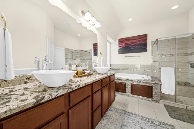 a spacious bathroom with a granite countertop sink and a mirror