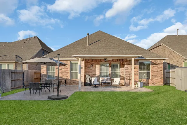 a front view of a house with patio and garden
