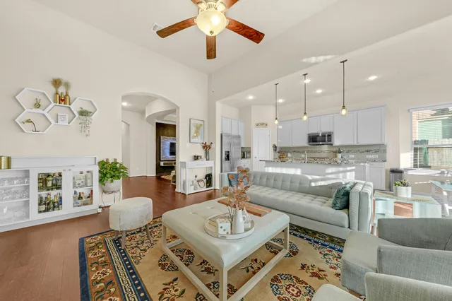 a living room with furniture and a wooden floor