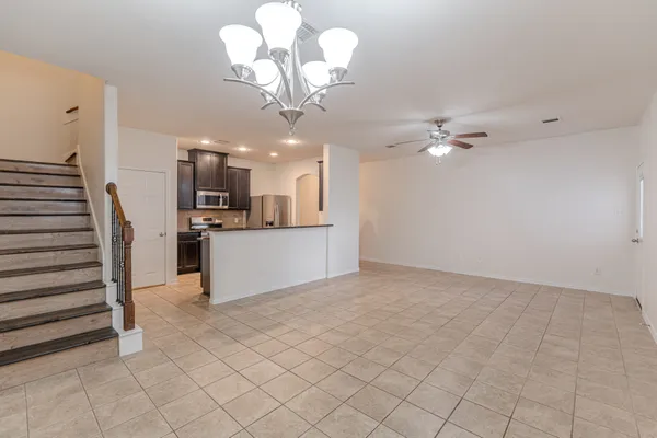 a view of a kitchen with a sink cabinets and chandelier