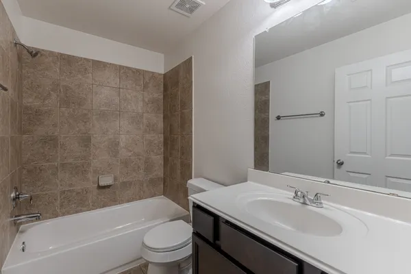 a bathroom with a sink a toilet and a bathtub