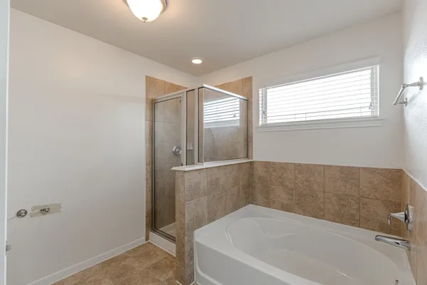 a bathroom with bathtub and window