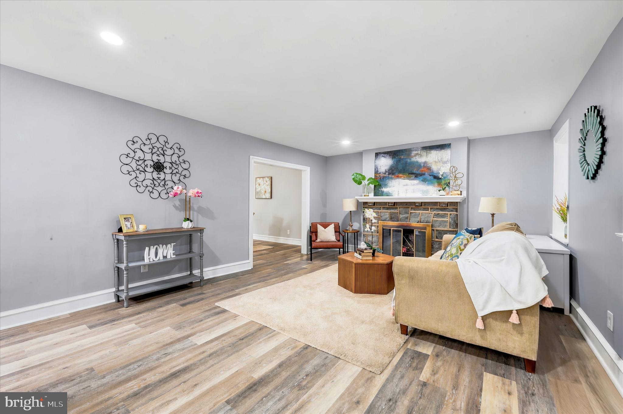 7208 Hilltop Road Upper Darby, PA 19082 - Photo 5 of 28 a living room with furniture a fireplace and a wooden floor