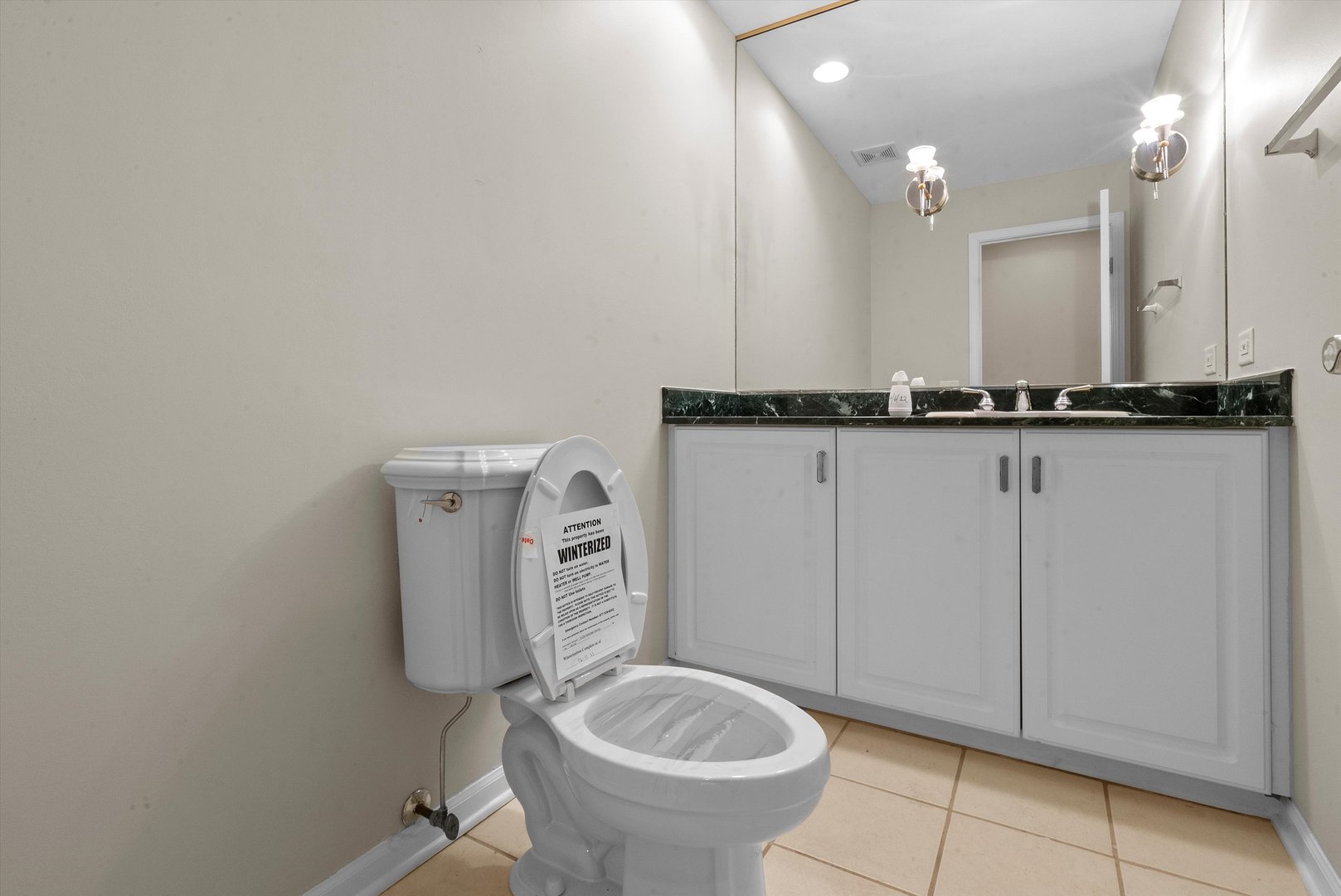 341 Rivershire Court Lincolnshire, IL 60069 - Photo 11 of 32 a bathroom with a toilet a sink and mirror