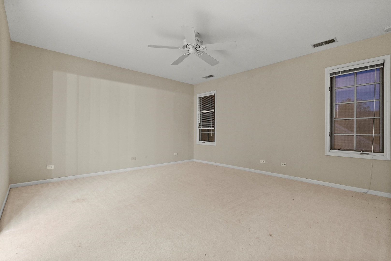 341 Rivershire Court Lincolnshire, IL 60069 - Photo 28 of 32 an empty room with a ceiling fan and windows