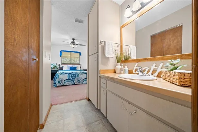 a bathroom with a sink a mirror and next to a window