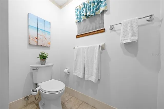 a white toilet sitting next to a bathroom sink