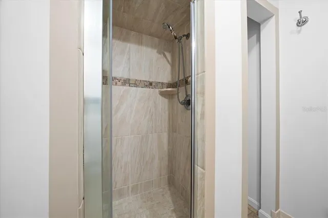 a bathroom with a glass shower door
