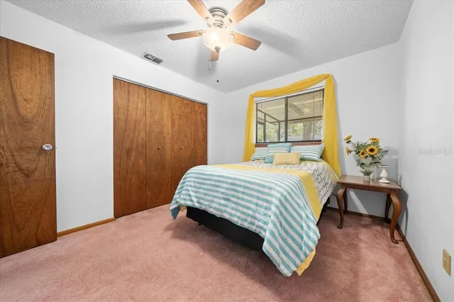 a bedroom with a bed table and window