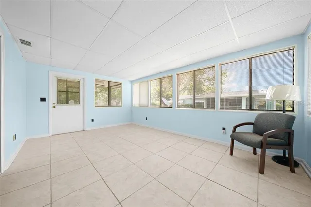 a view of a bedroom with furniture and windows