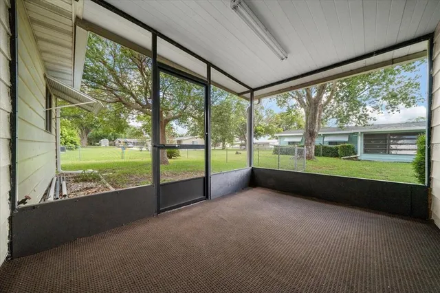 a view of an empty room with a large window