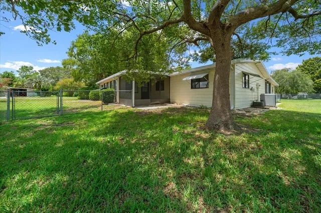 a yellow house in middle of the forest