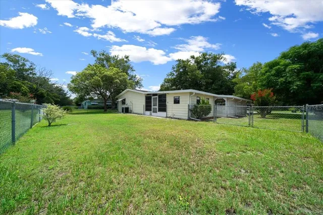 a view of house with backyard