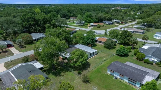 an aerial view of multiple houses with yard