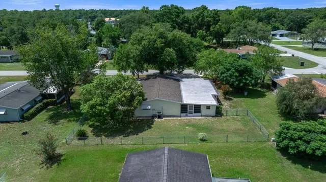 an aerial view of a house with yard and green space