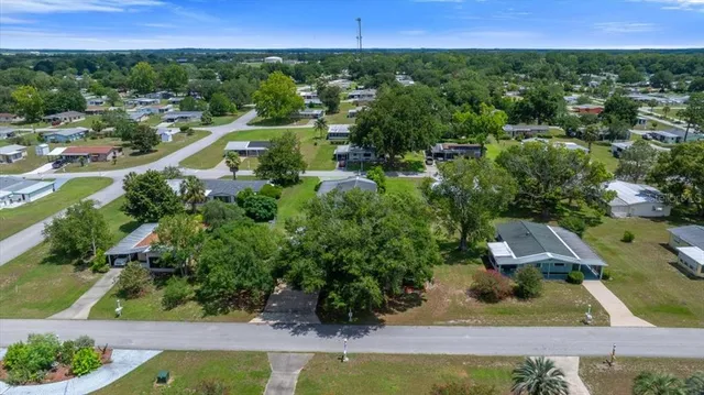an aerial view of residential houses with outdoor space and swimming pool