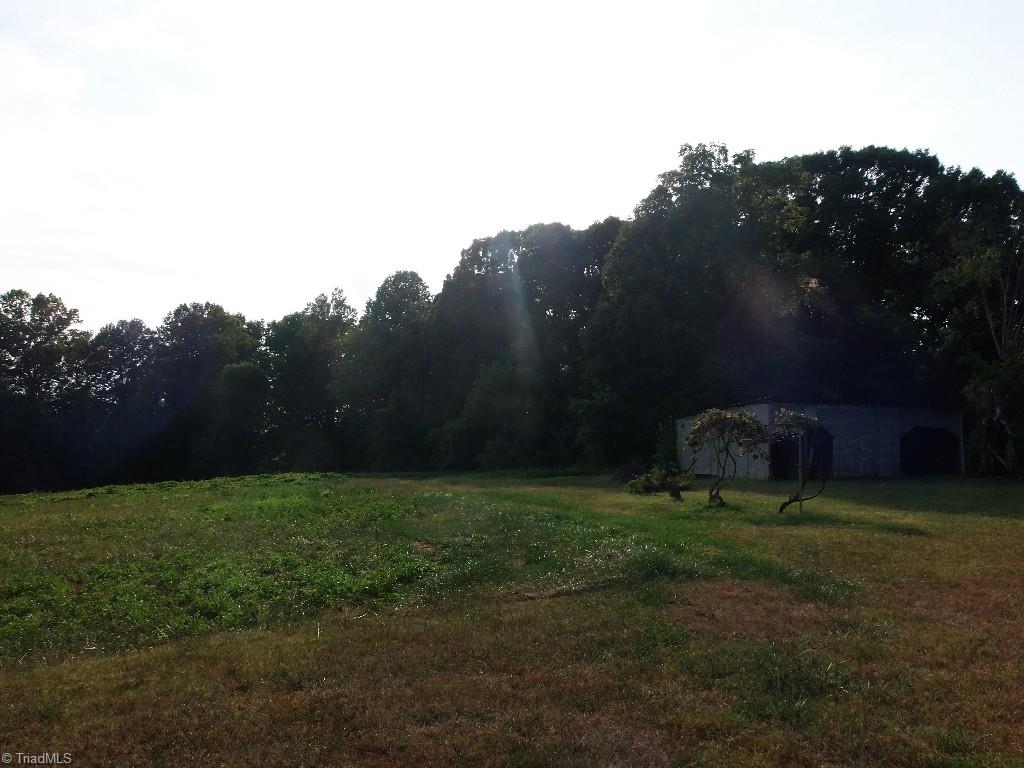 Behind house with a usable storage shed. 