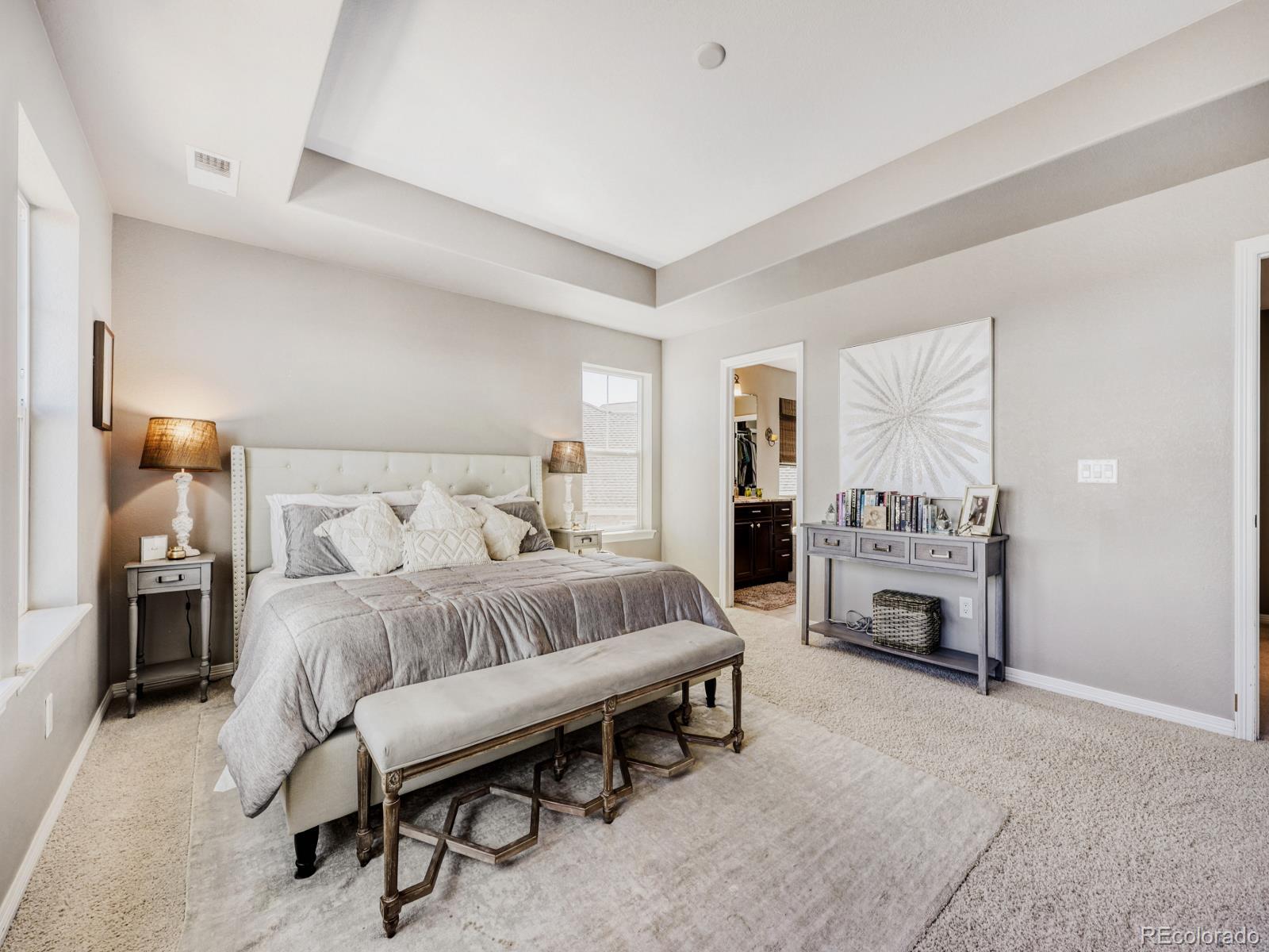 2964 Whitewing Way Castle Rock, CO 80108 - Photo 16 of 31 a spacious bedroom with a bed a table and a couch