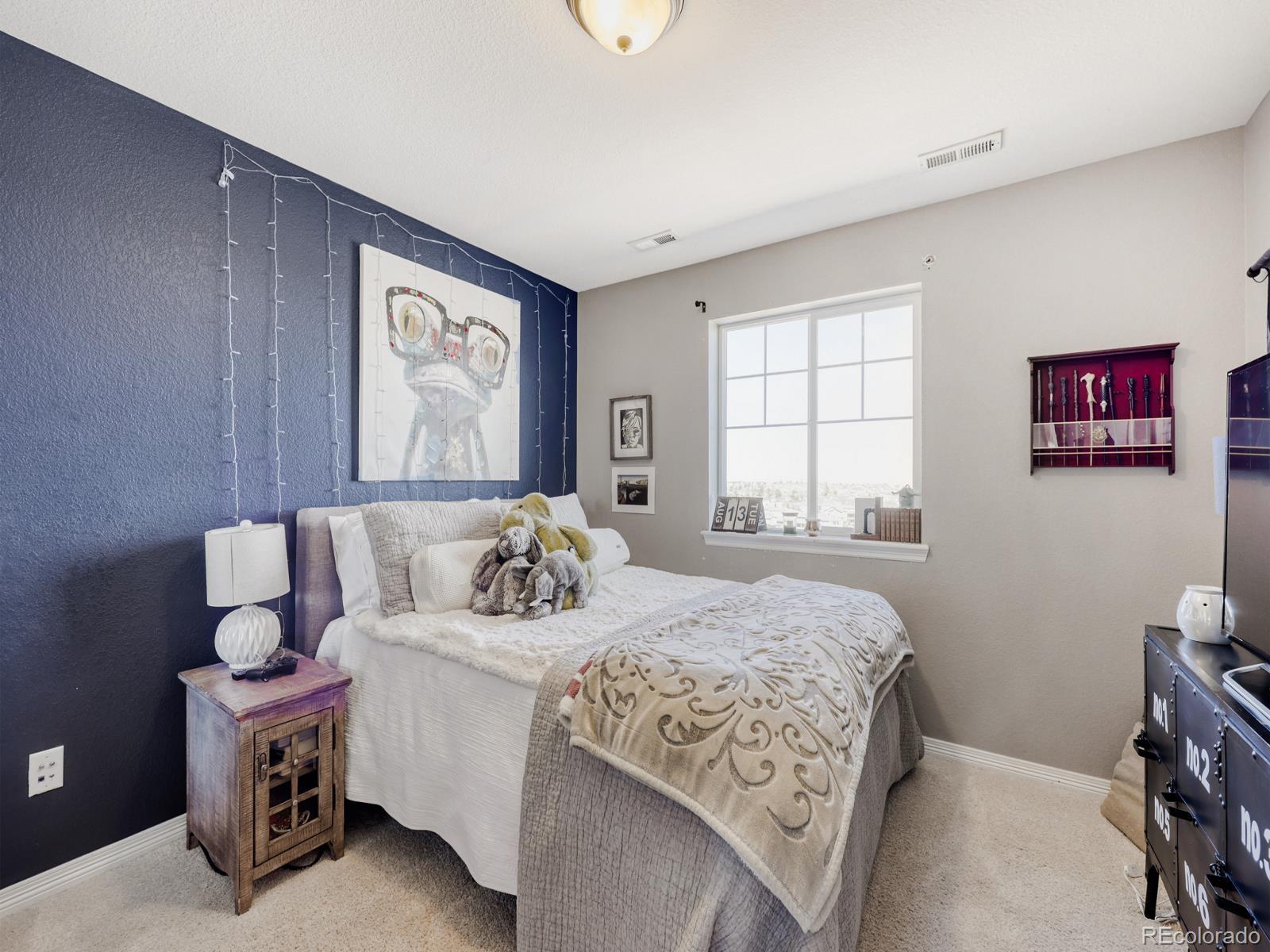 2964 Whitewing Way Castle Rock, CO 80108 - Photo 21 of 31 a bedroom with bed and a window