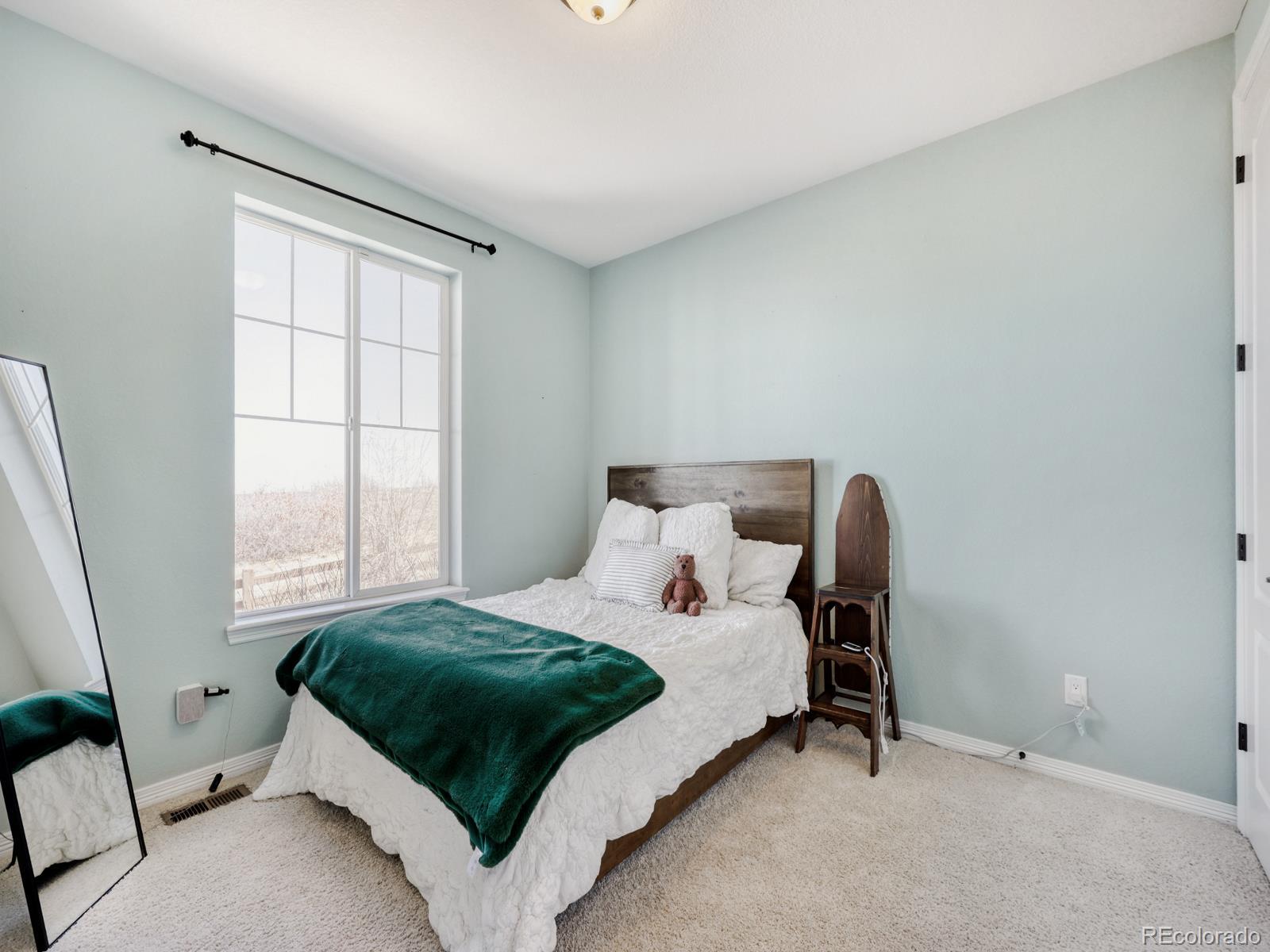 2964 Whitewing Way Castle Rock, CO 80108 - Photo 25 of 31 a bedroom with a bed and wooden floor