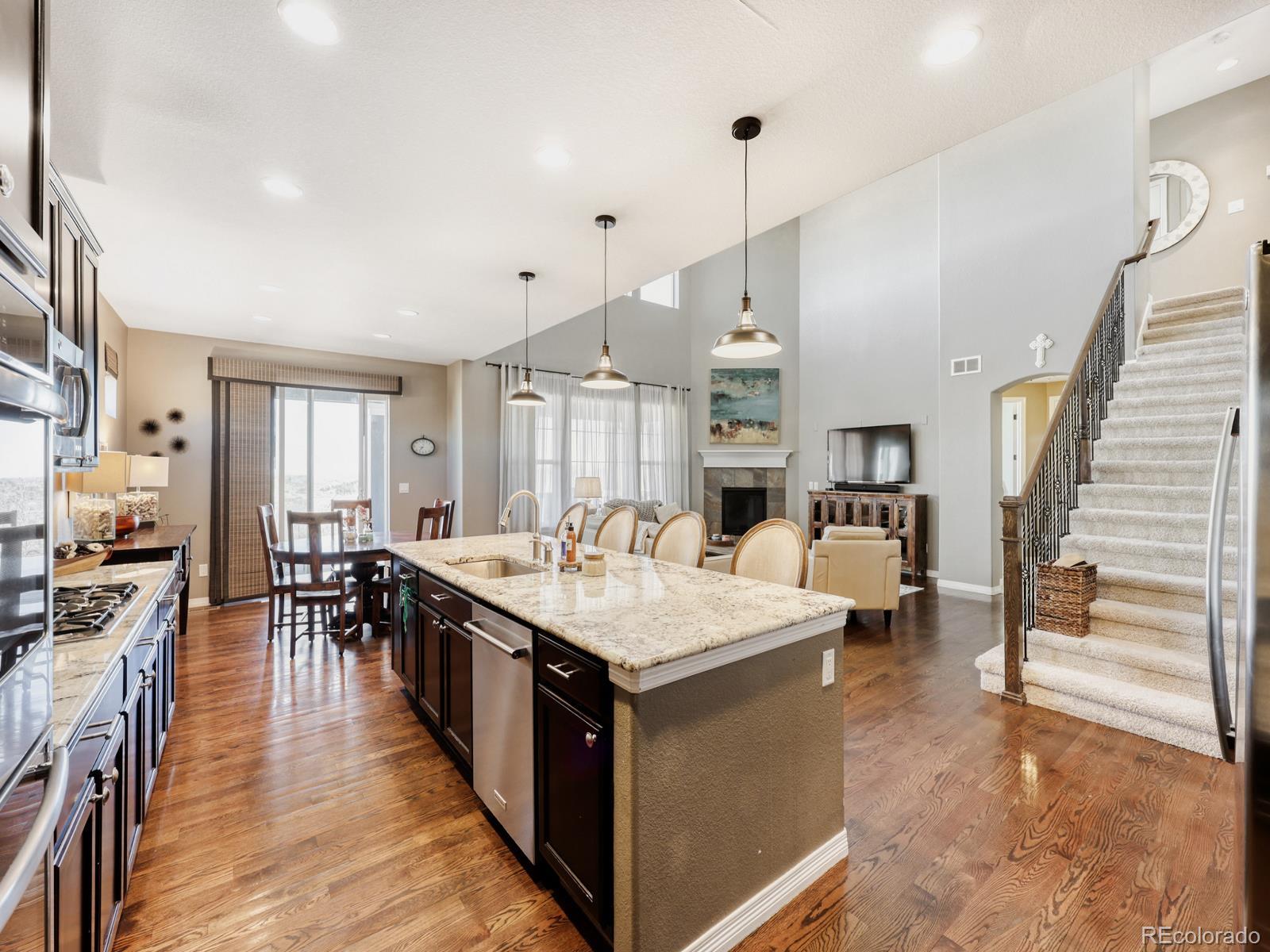 2964 Whitewing Way Castle Rock, CO 80108 - Photo 8 of 31 a large white kitchen with a large island in the center