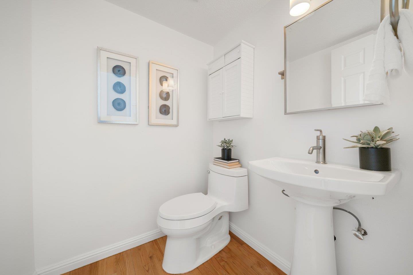 603 Cornwallis Lane Foster City, CA 94404 - Photo 13 of 36 a bathroom with a toilet sink and mirror