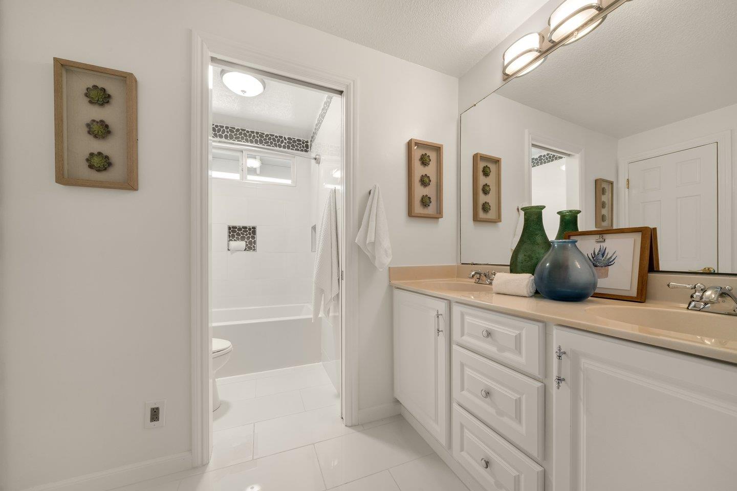 603 Cornwallis Lane Foster City, CA 94404 - Photo 29 of 36 a bathroom with a granite countertop sink a mirror a vanity and a shower