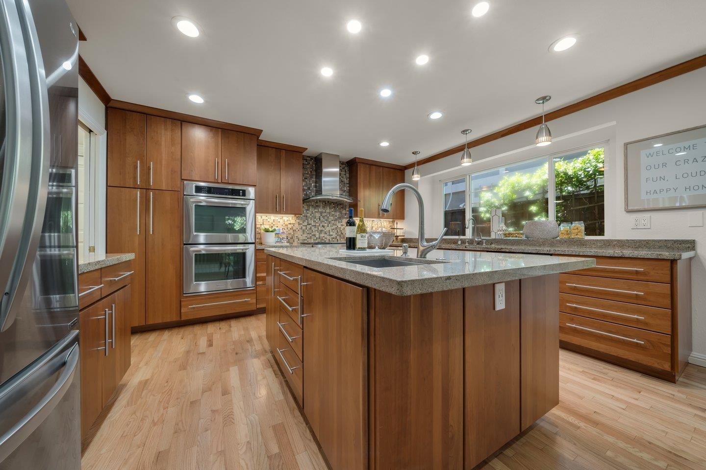 603 Cornwallis Lane Foster City, CA 94404 - Photo 9 of 36 a kitchen with kitchen island granite countertop a sink stainless steel appliances and cabinets