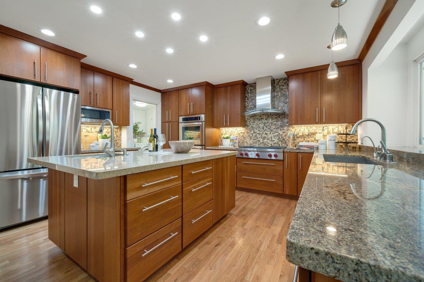 603 Cornwallis Lane Foster City, CA 94404 - Photo 10 of 36 a kitchen with kitchen island granite countertop wooden cabinets a sink and stainless steel appliances