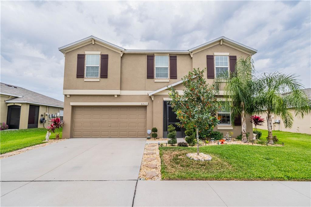 2213 4th Street Southwest Ruskin, FL 33570 - Photo 1 of 1 a front view of a house with a yard and garage