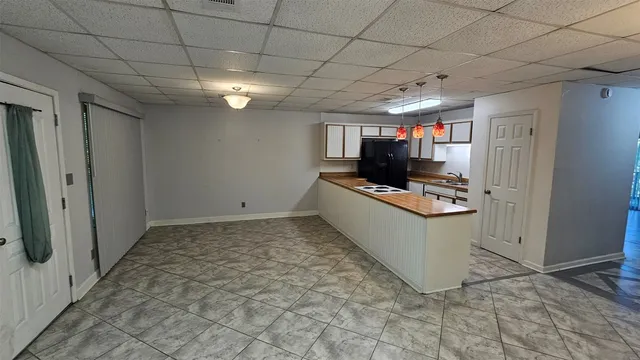 a kitchen with granite countertop lots of counter top space and refrigerator