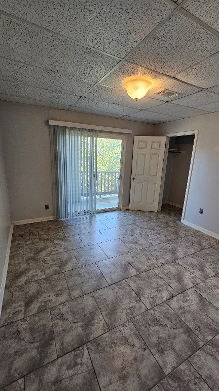 170 Interstate Drive, Unit B Buda, TX 78610 - Photo 9 of 11 a view of an empty room with wooden floor and a window
