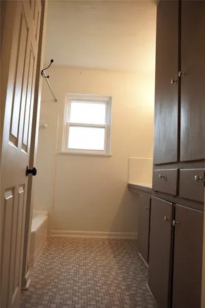 an empty room with wooden floor and a window