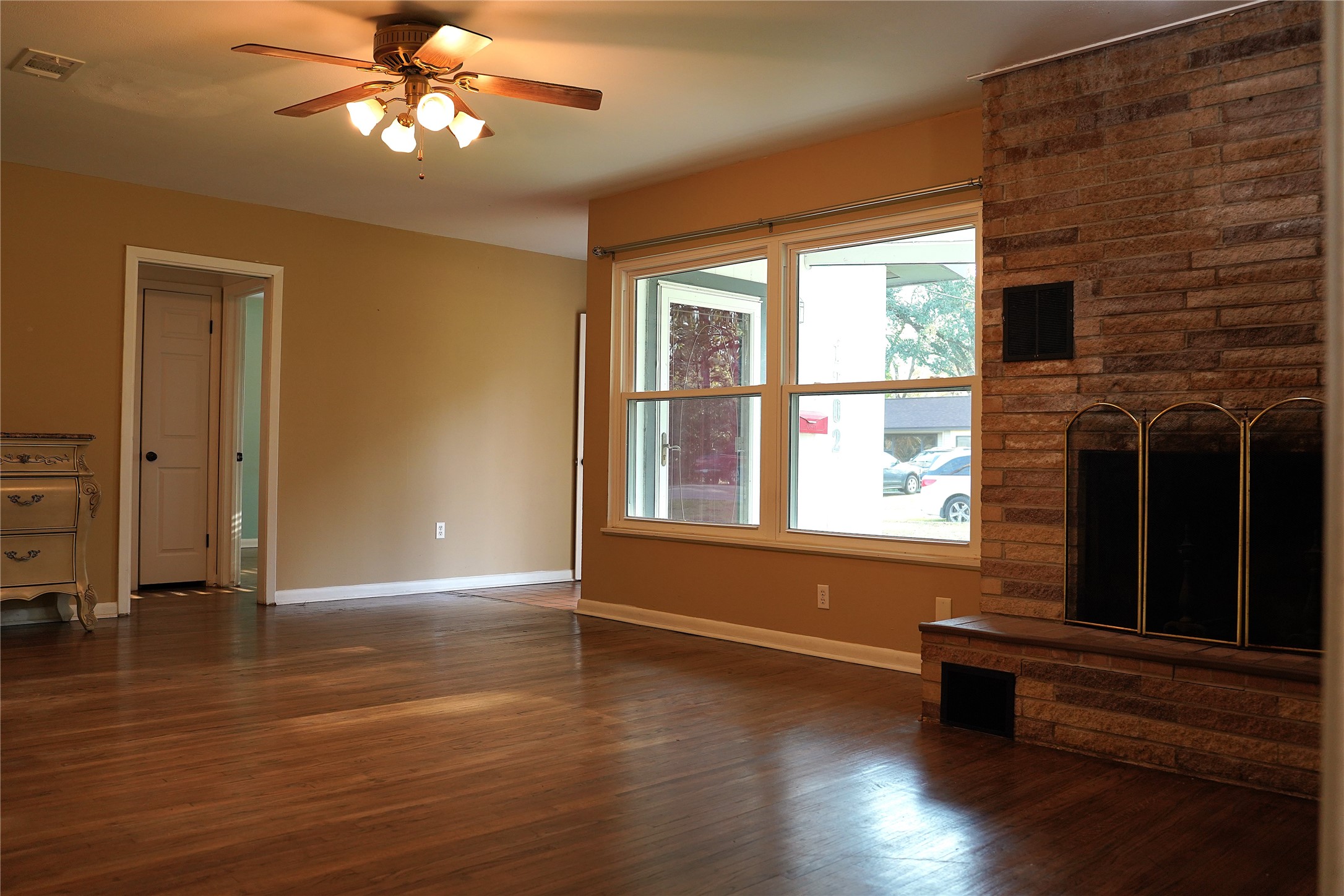 1202 Mac Drive Sweeny, TX 77480 - Photo 3 of 12 a view of an empty room with wooden floor and a window