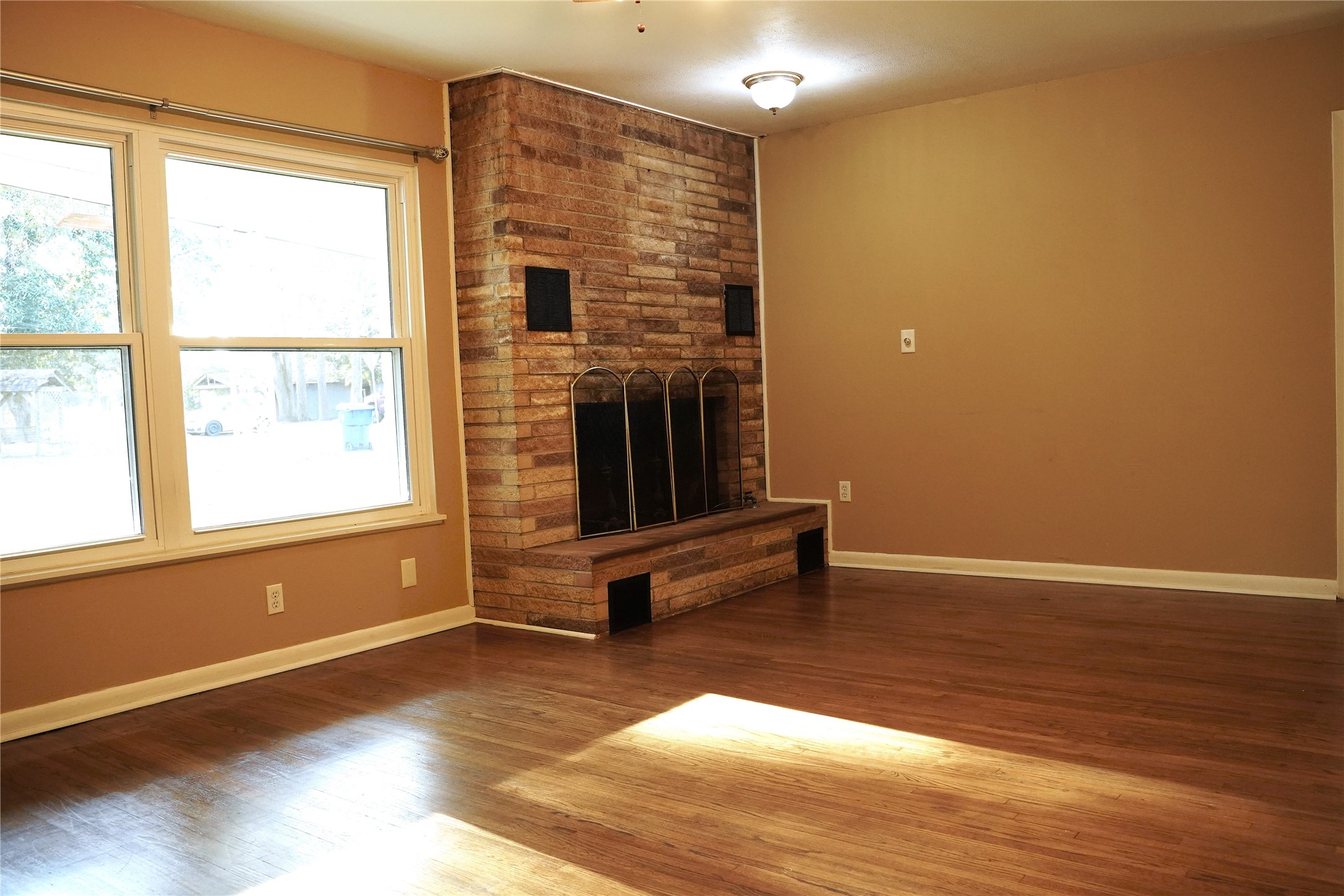 1202 Mac Drive Sweeny, TX 77480 - Photo 4 of 12 a view of an empty room with wooden floor and a window
