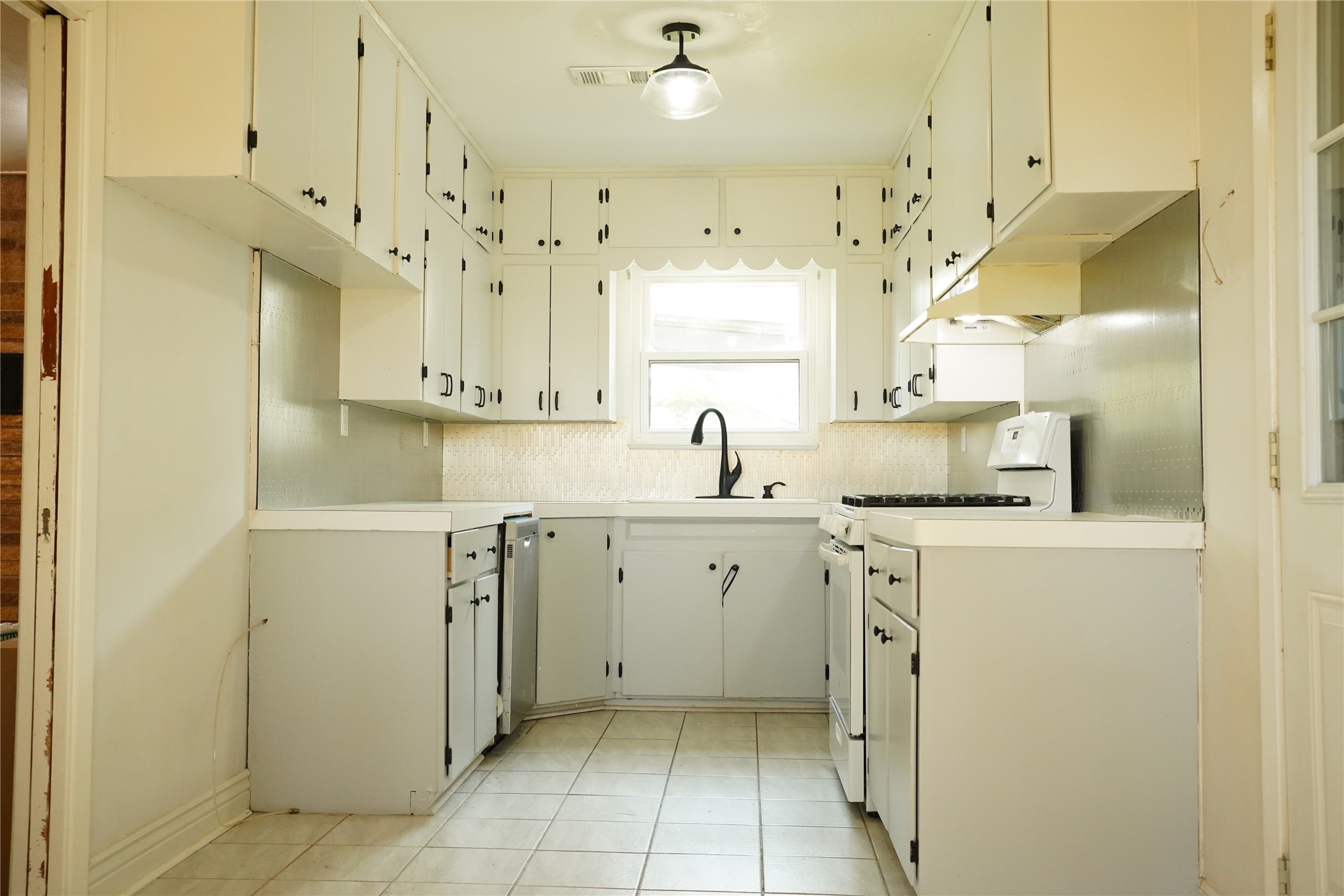 1202 Mac Drive Sweeny, TX 77480 - Photo 5 of 12 a kitchen with a sink a stove and cabinets
