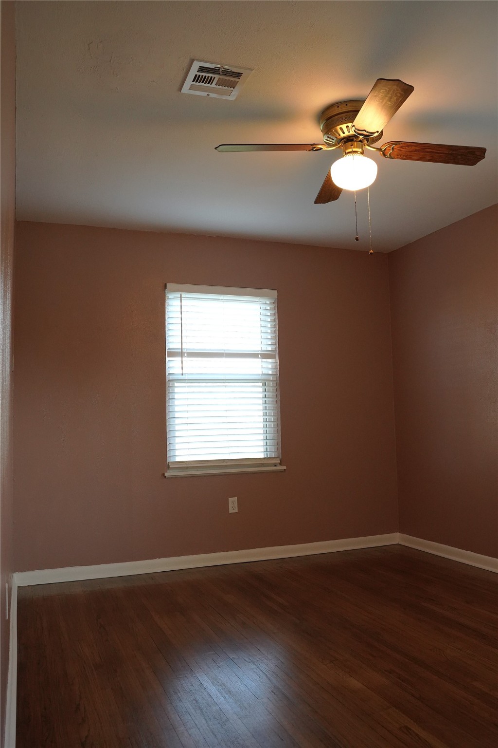 1202 Mac Drive Sweeny, TX 77480 - Photo 8 of 12 a view of an empty room with wooden floor and a window