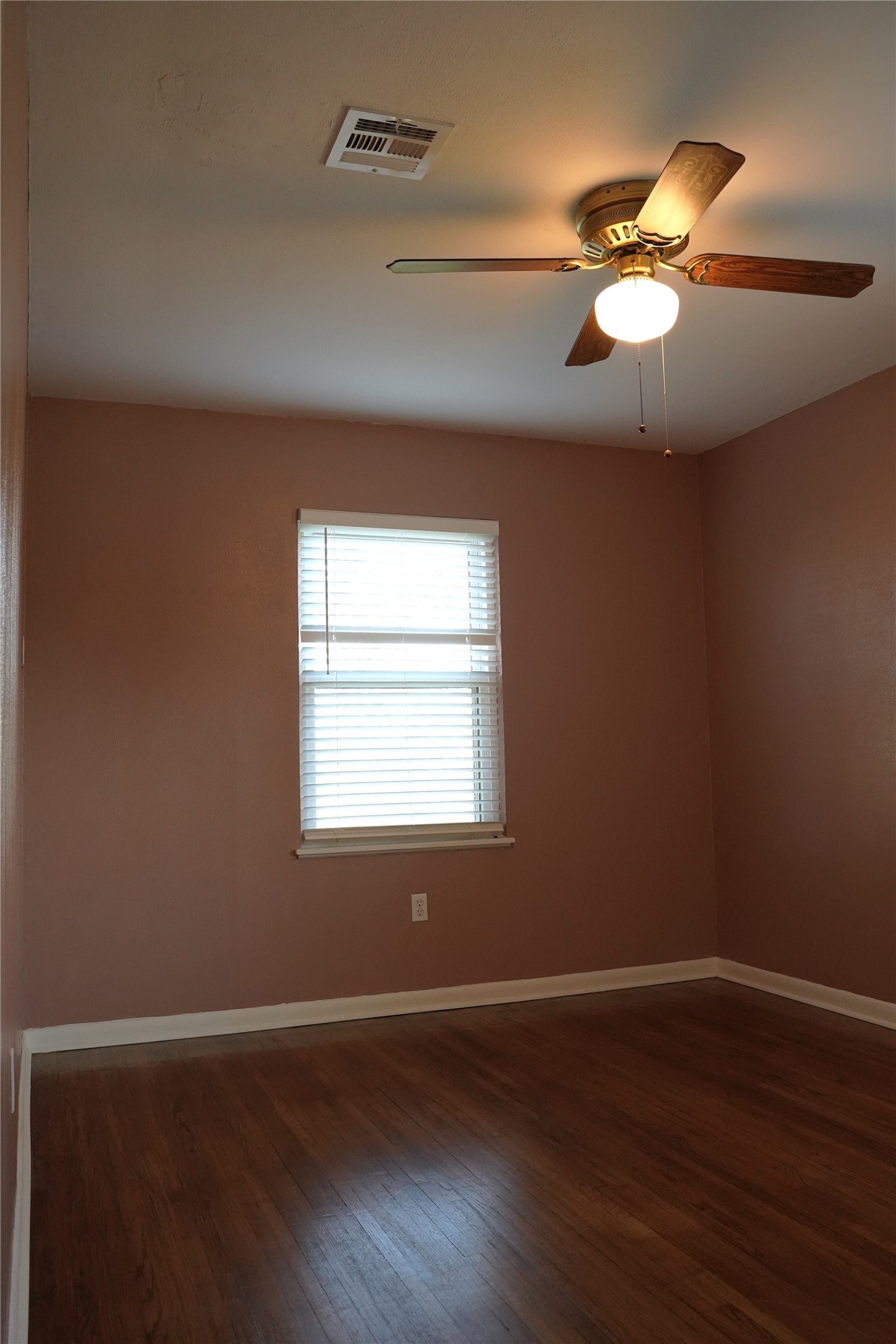 1202 Mac Drive Sweeny, TX 77480 - Photo 8 of 12 a view of an empty room with wooden floor and a window