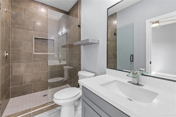 a bathroom with a sink toilet and shower