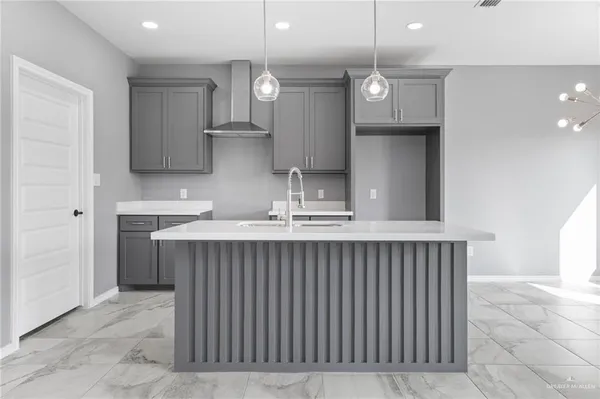 a kitchen with a sink a counter space appliances and cabinets