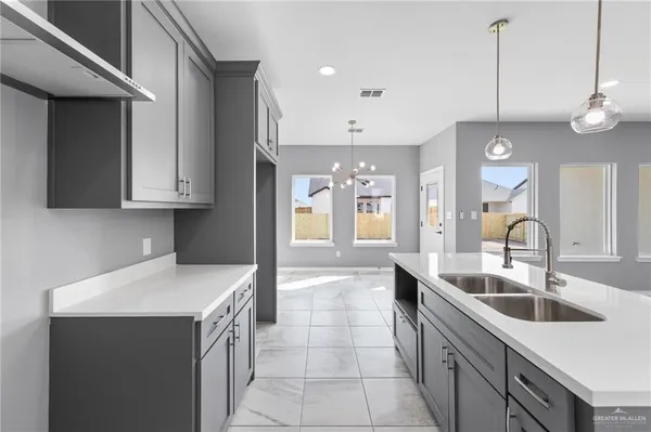 a kitchen with a sink a counter space cabinets and stainless steel appliances