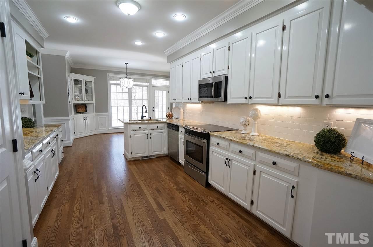 204 Veranda Court Raleigh, NC 27615 - Photo 5 of 25 Bright & Spacious Kitchen has SS Appliances, Granite Counter Tops & Large Pantry.