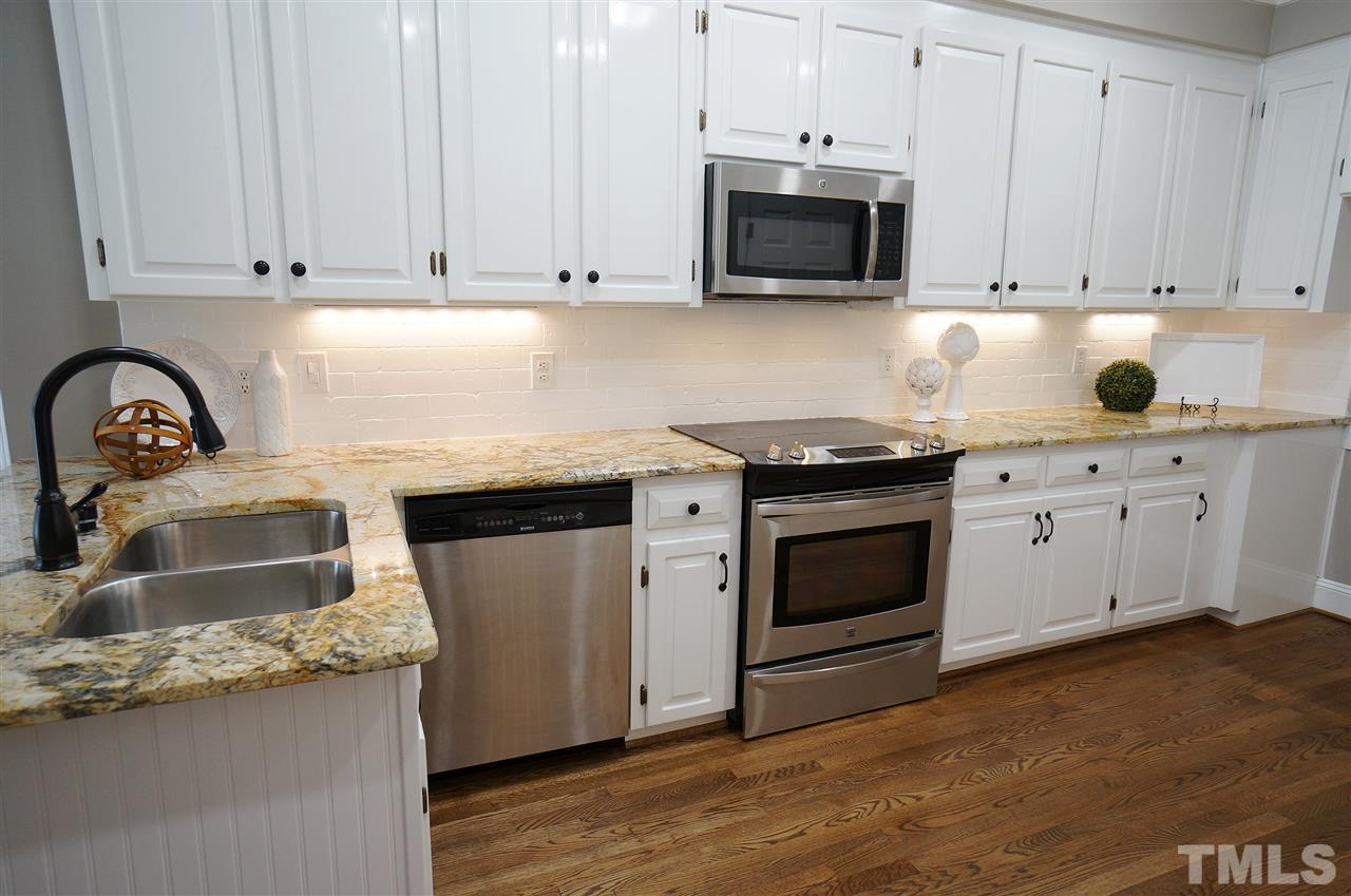 204 Veranda Court Raleigh, NC 27615 - Photo 6 of 25 Bright & Spacious Kitchen has SS Appliances, Granite Counter Tops & Large Pantry.