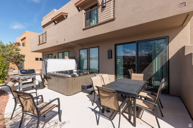 4845 Fishers Is Way St. George, UT 84770 - Photo 27 of 41 Patio / terrace with a hot tub, a patio, outdoor dining space, and grilling area