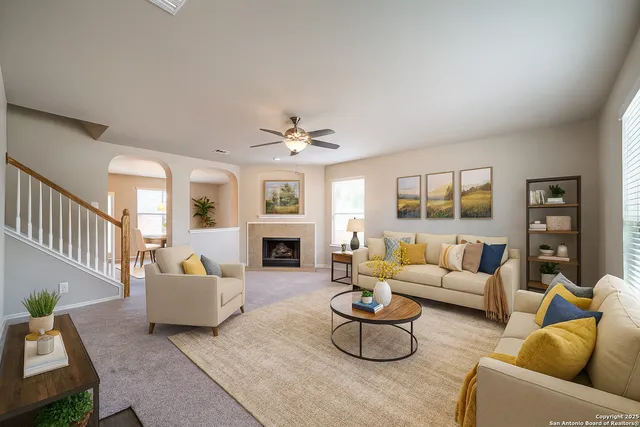 a living room with furniture and a fireplace