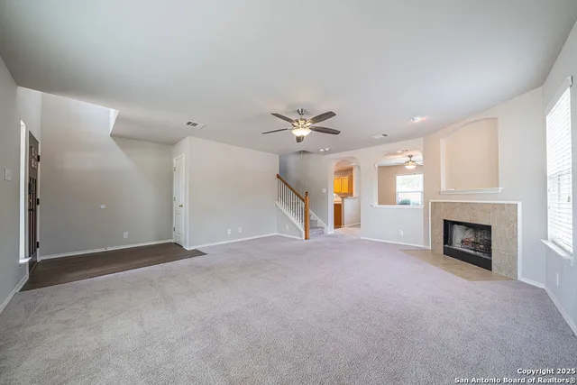 a view of empty room with a fireplace