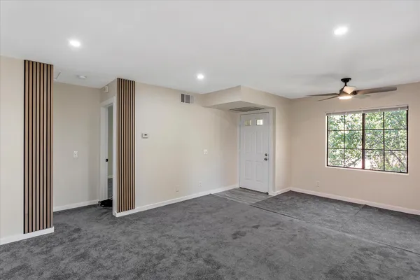 a view of an empty room with a window