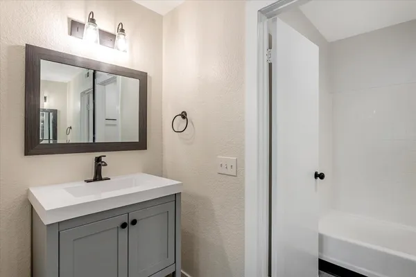 a bathroom with a shower a toilet and sink
