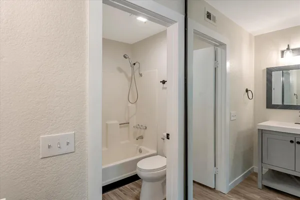 a bathroom with a sink a toilet and a mirror