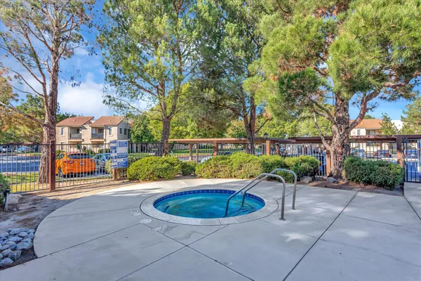 a front view of a house with a garden and plants